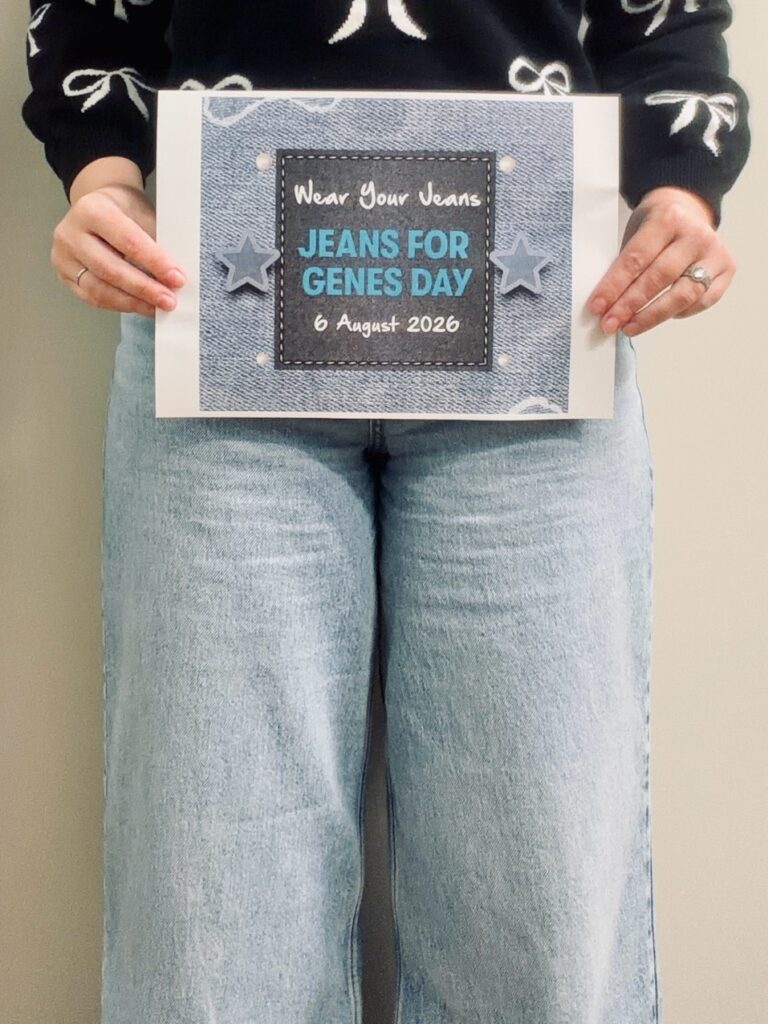 Person holding a poster promoting genes for jeans day.